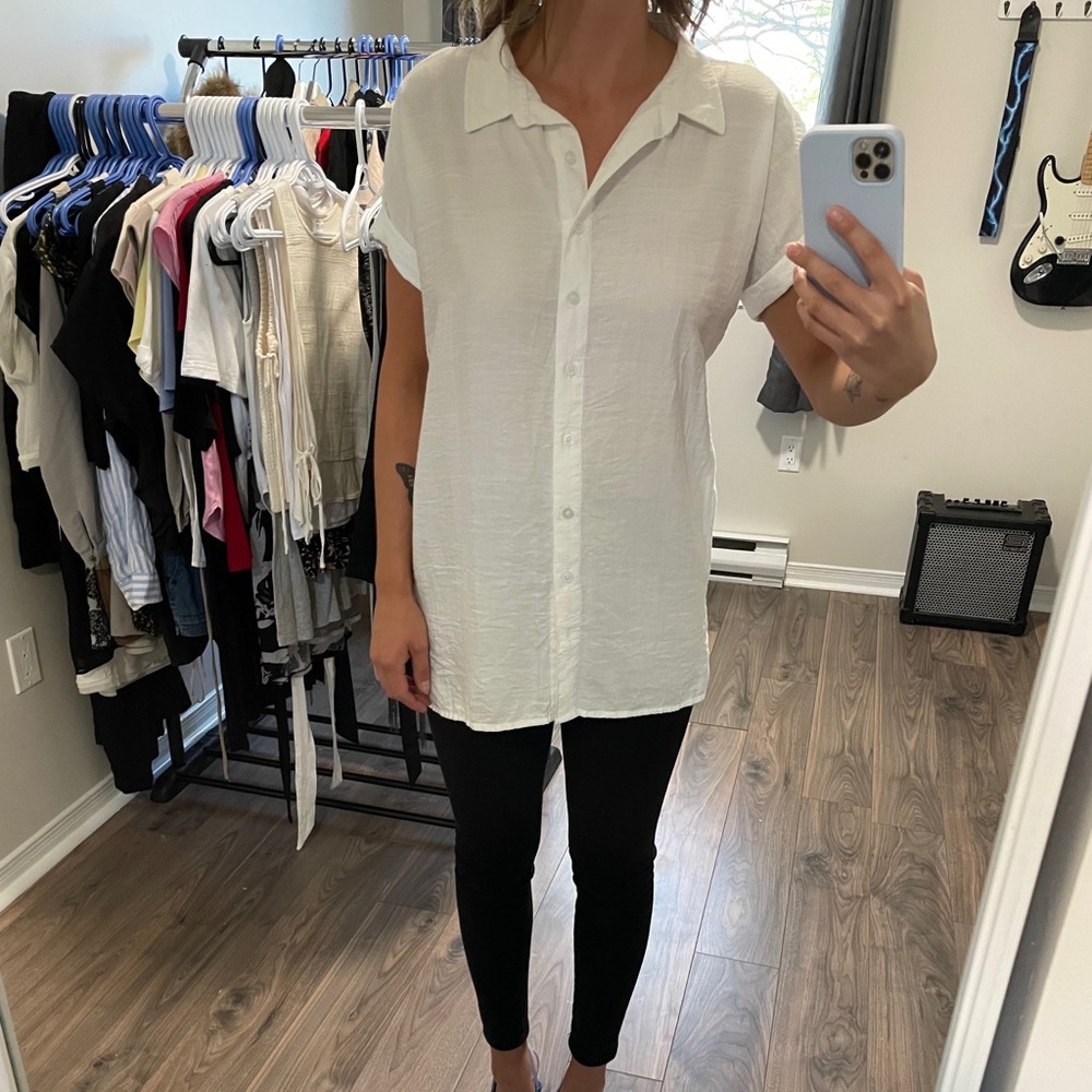 White button up T-shirt blouse. Designer is Carolina Herrera.